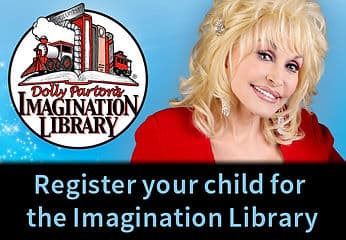 Dolly Parton holding a children's book